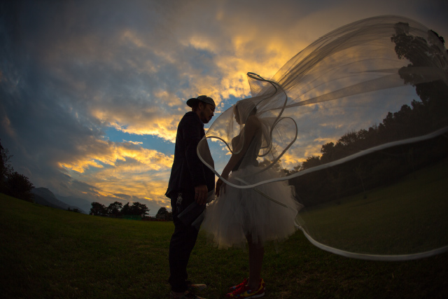 結婚式を挙げていない夫婦のために、友人がサプライズで行ったフォトウェディングの一幕です。タイミング良く、風まで二人を祝福しているようでした。